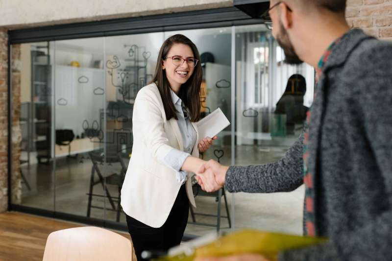 Openly greeting a job recruiter with a firm handshake