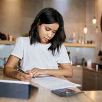 Woman looking over business loan papers