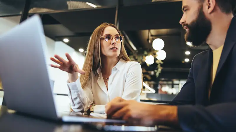 Two people having a business meeting in an office space