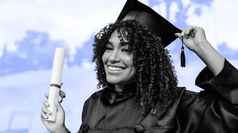 Young college graduate holding diploma, wearing a cap and gown