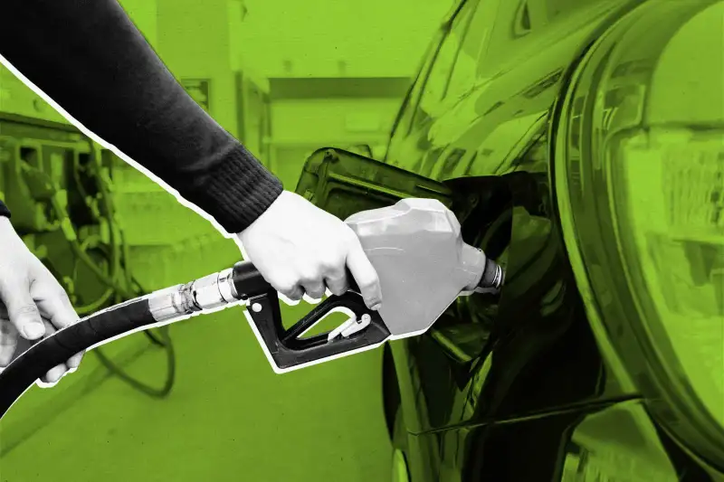 Close up of a hand filling up a car gas tank