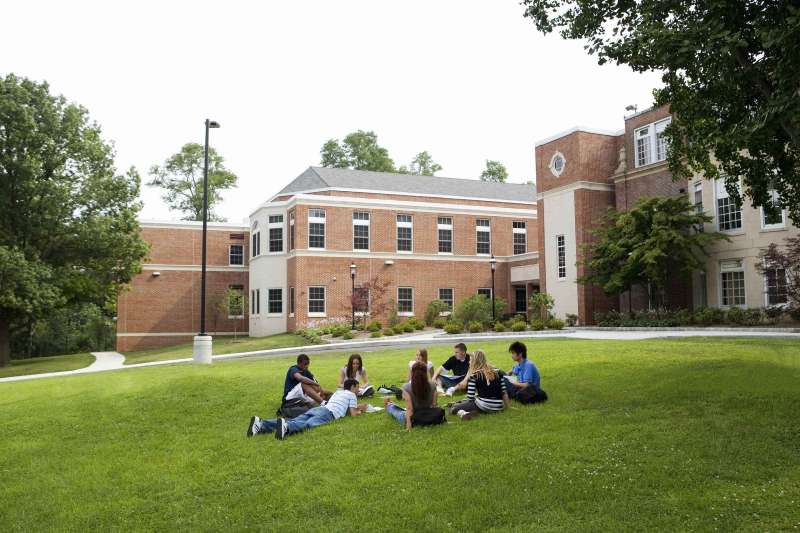 Group of college students studying outdoors on campus