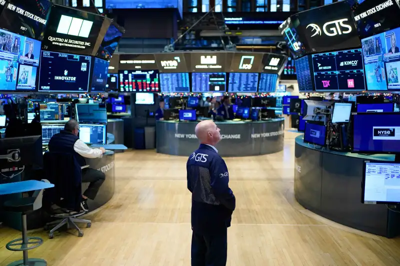 Traders work on the floor at the New York Stock Exchange