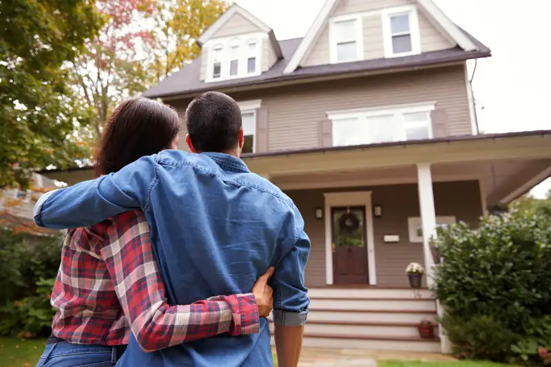 Couple looking at the house they just purchased