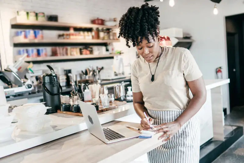 Young coffee shop owner working on accounting problems