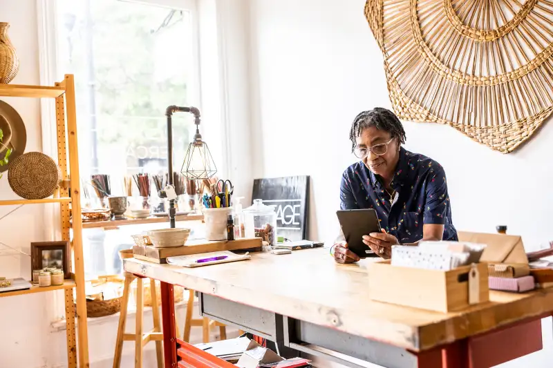 Female small business using smartphone in her store