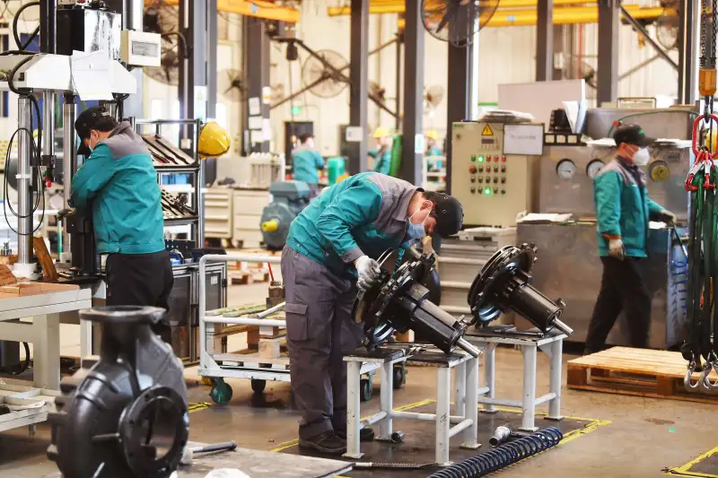 Workers manufacture pumps at Wilo Group's Beijing branch company on January 4, 2023 in Beijing, China