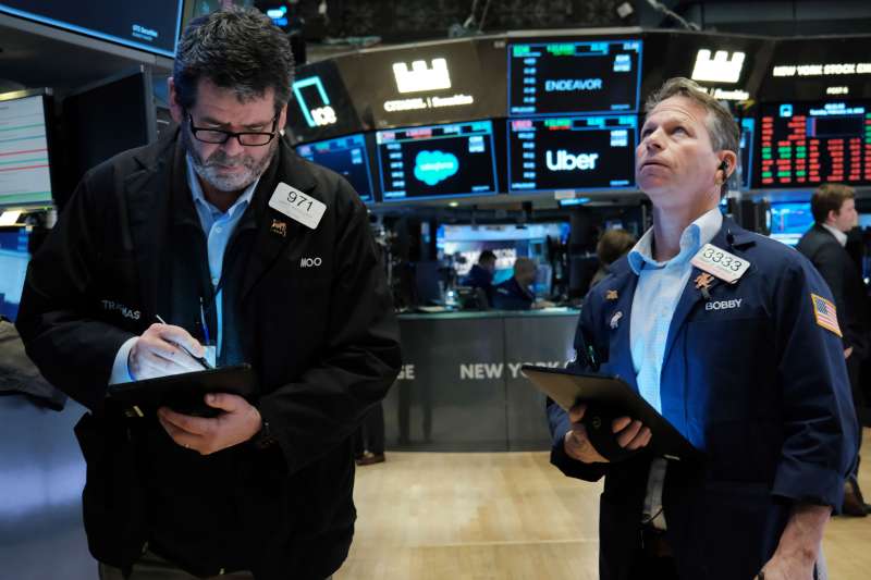 Two traders work on the floor of the New York Stock Exchange (