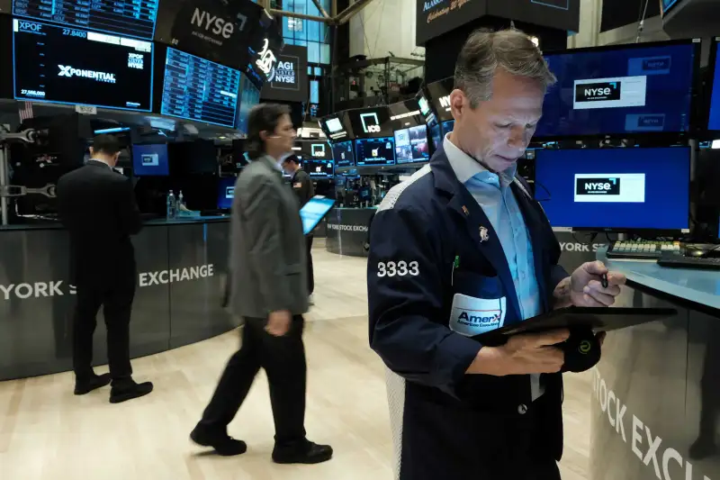 Traders work on the floor of the New York Stock Exchange