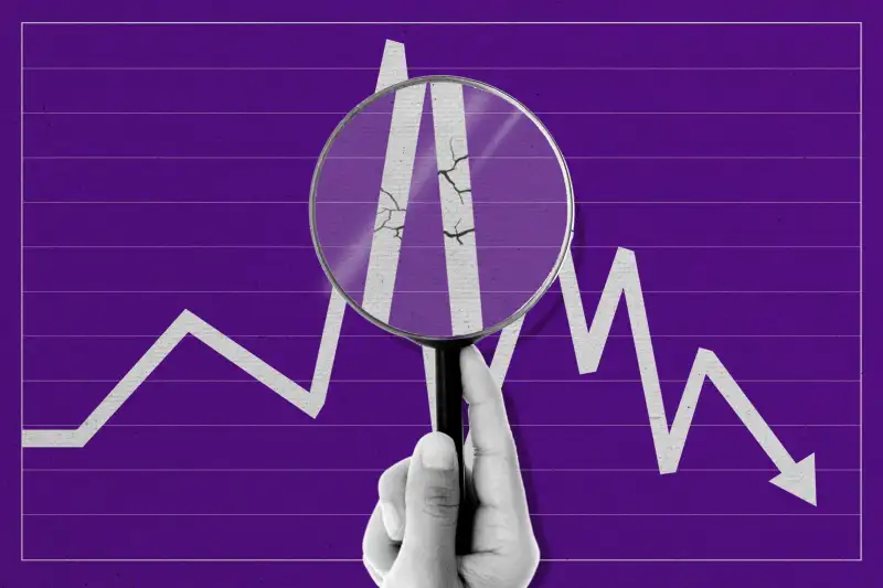 Hand Holding Magnifying Glass Over Line Chart