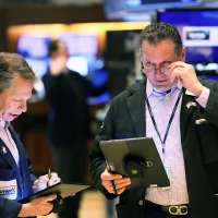 Traders work on the floor of the New York Stock Exchange (NYSE) during morning trading in New York City
