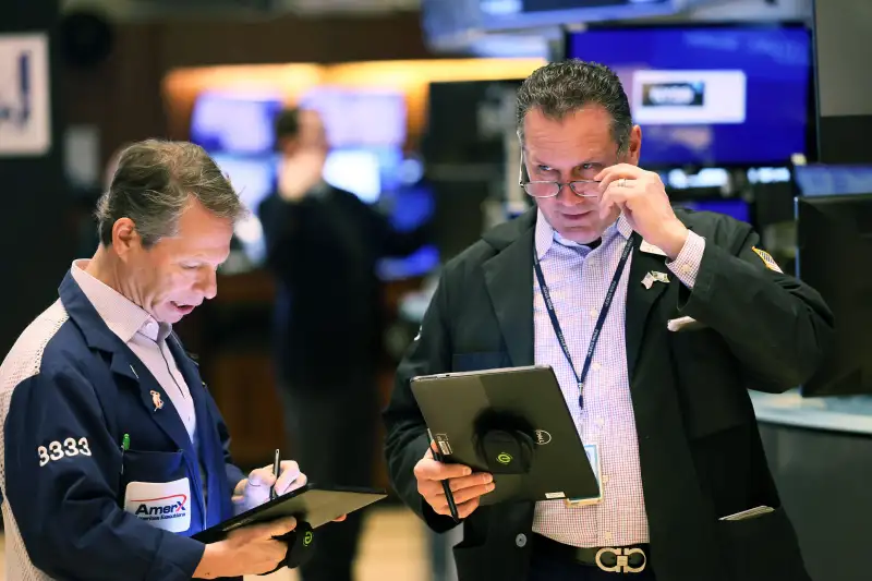 Traders work on the floor of the New York Stock Exchange (NYSE) during morning trading in New York City