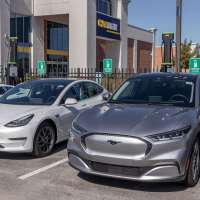 CarMax Auto Dealership Tesla and Mustang Mach-E display