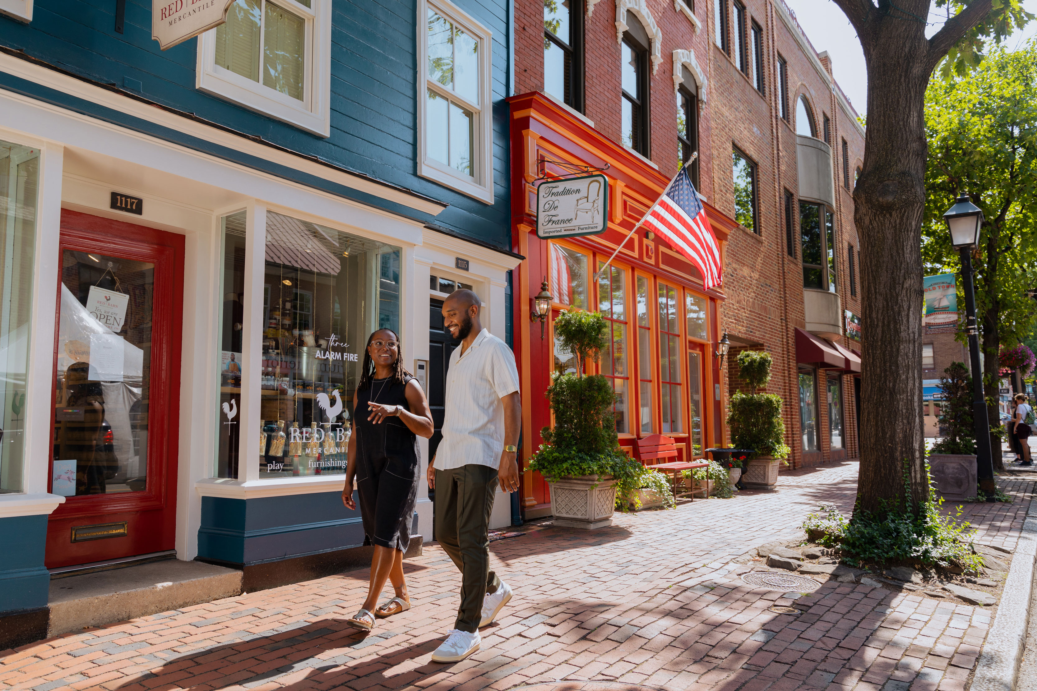 two people walking down a shopping street in Alexandria, Virginia