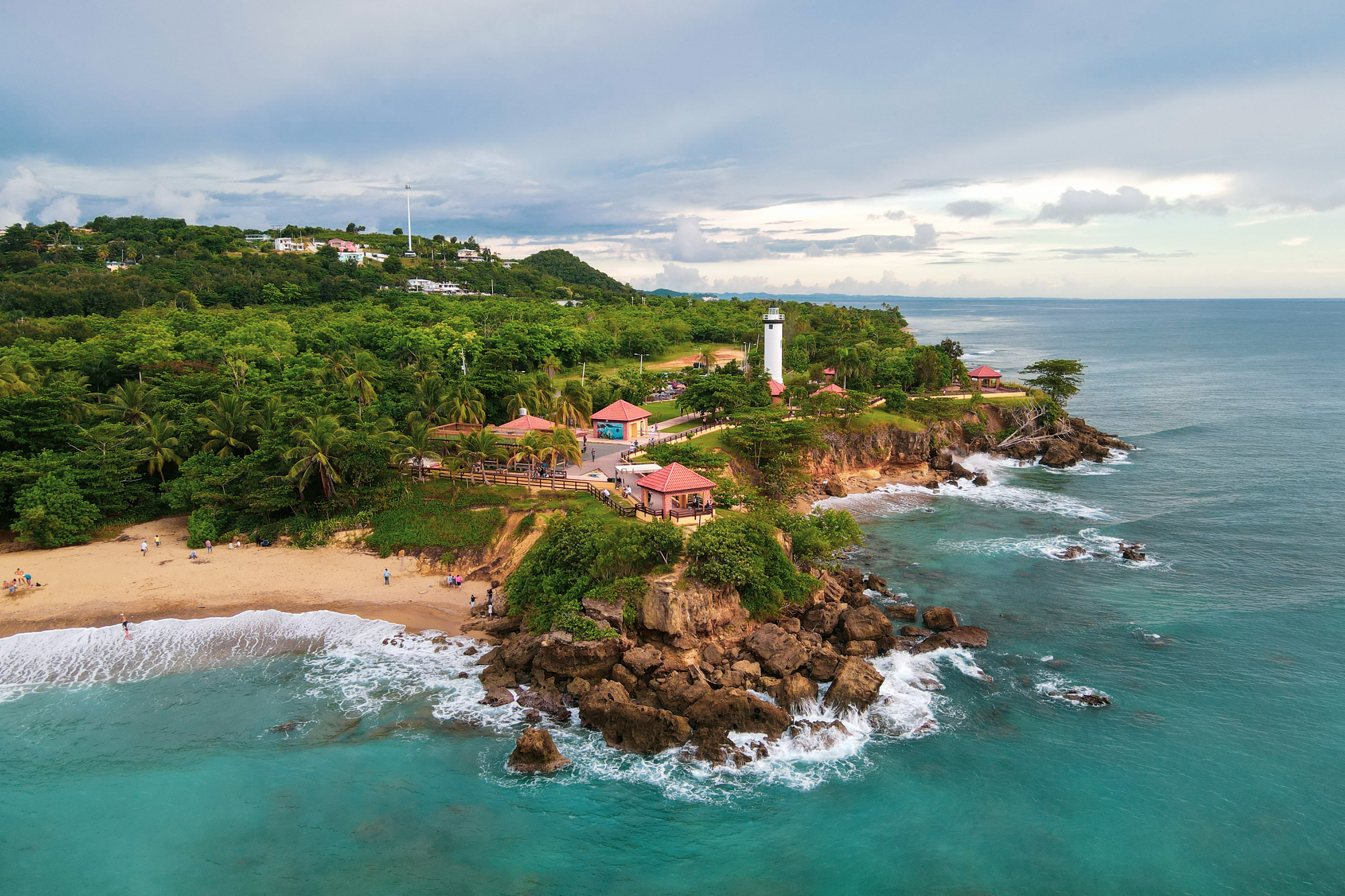 El Aerial Drone Photography of waves crashing near the lighthouse in Rincon, Puerto Rico