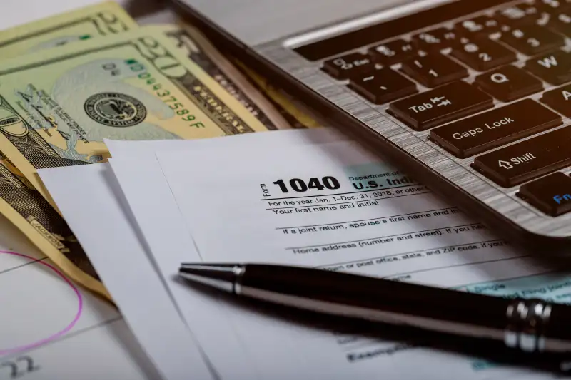 1040 US tax form, money and calendar with U.S dollars money and computer