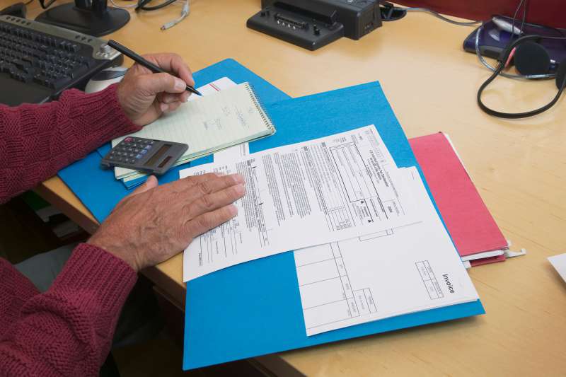 Mature man preparing tax forms, close-up