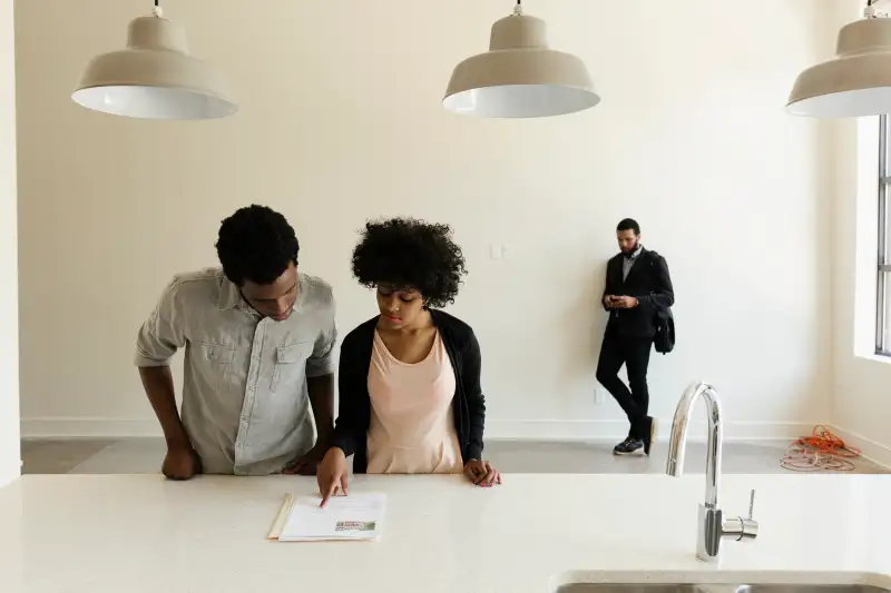 Couple reading paperwork in new house