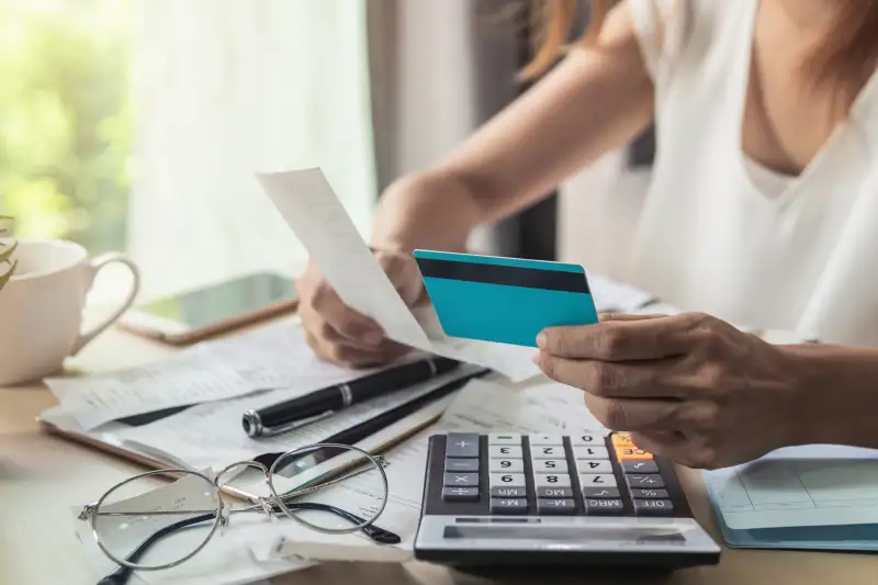 Close-up of a woman looking at credit card receipts