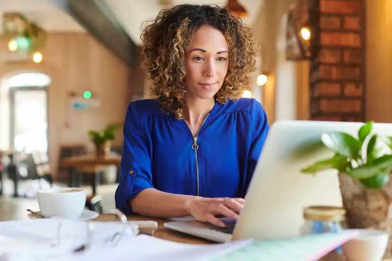 working from the cafe, woman brings her work to the cafe