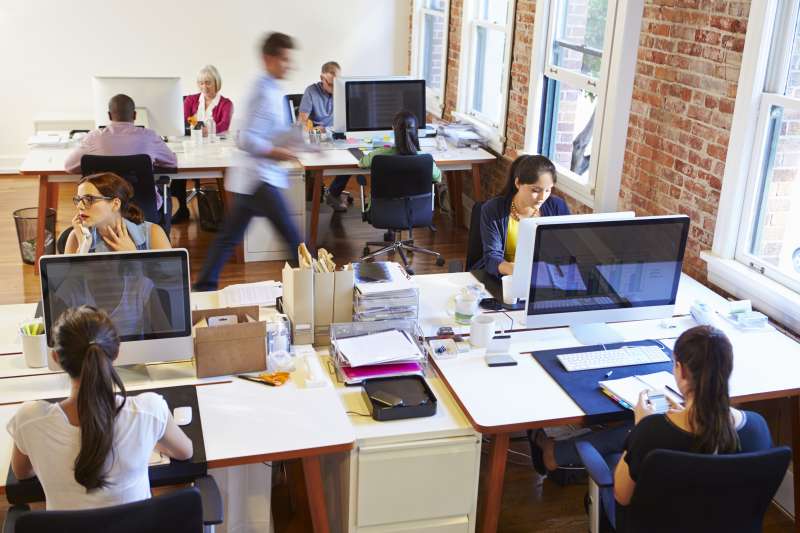 Group of people working from their desk in a corporate office space