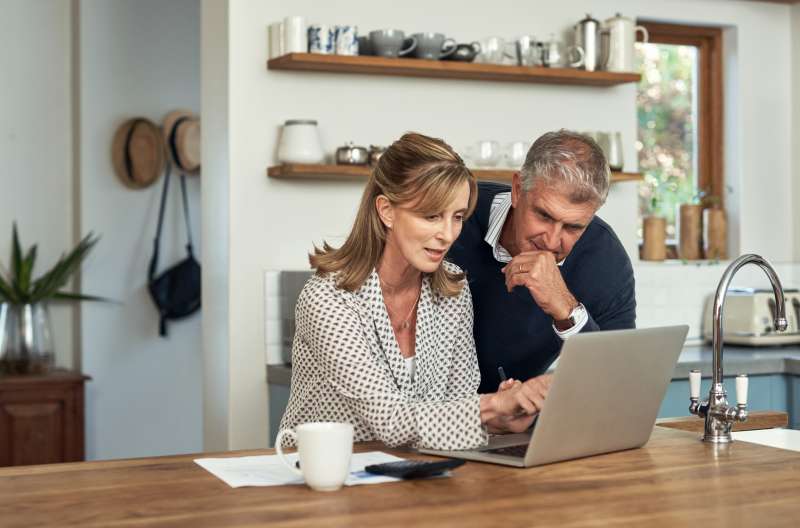 older couple looking at something on a laptop computer