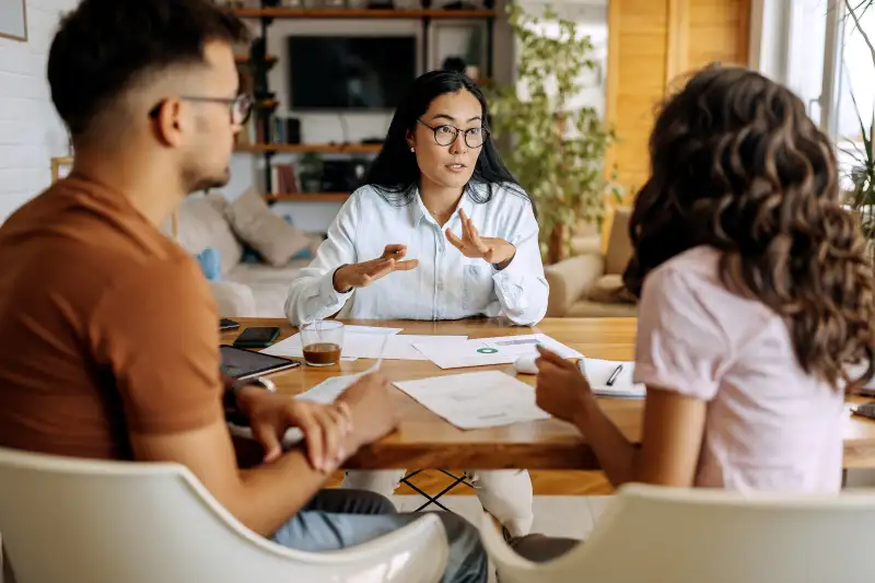 Young couple getting advice from financial expert