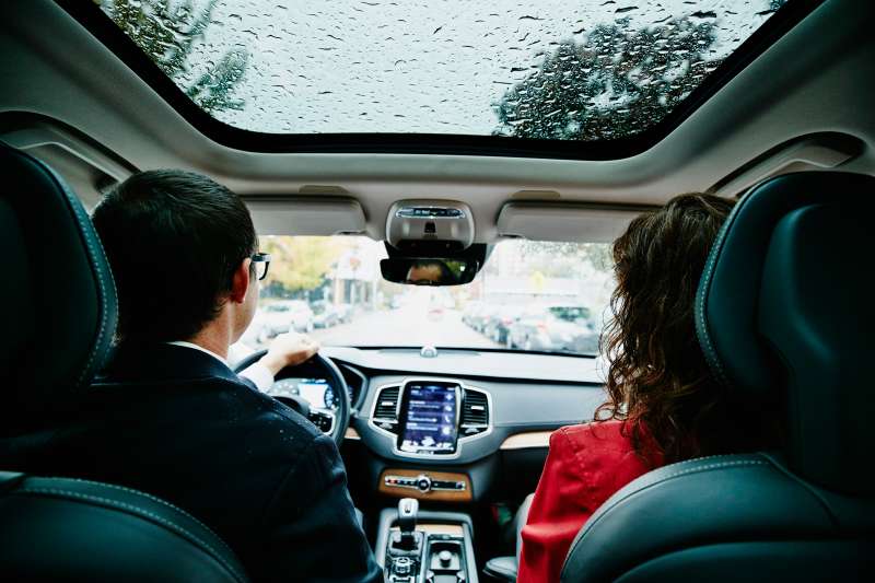 Couple commuting to work in car on rainy morning