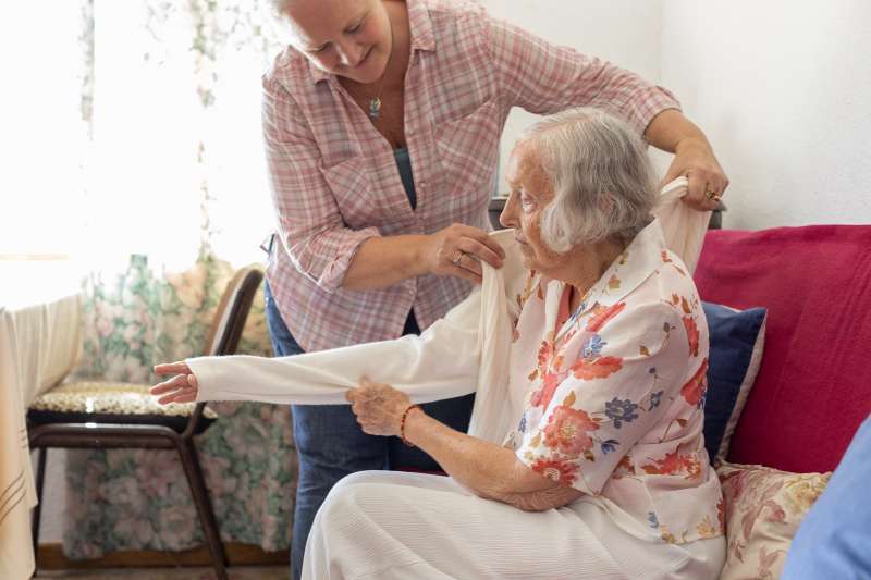 Mature woman caring for her elderly mother