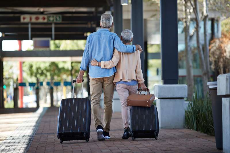 Senior couple walking together on public transport station