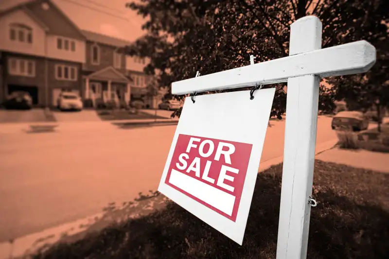 For Sale Sign In Front Of House