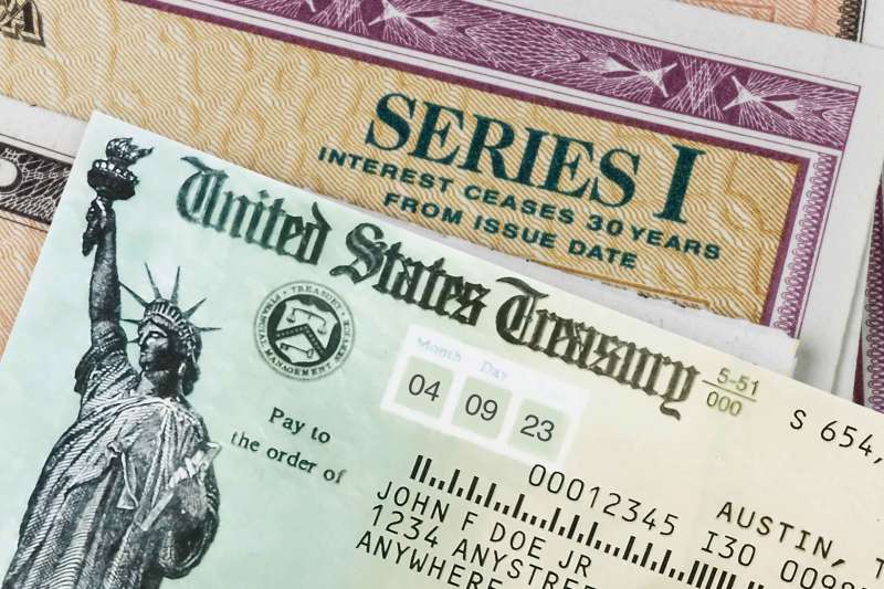 Close Up Of A United States Treasury Refund Check On Top Of A Series I Bond