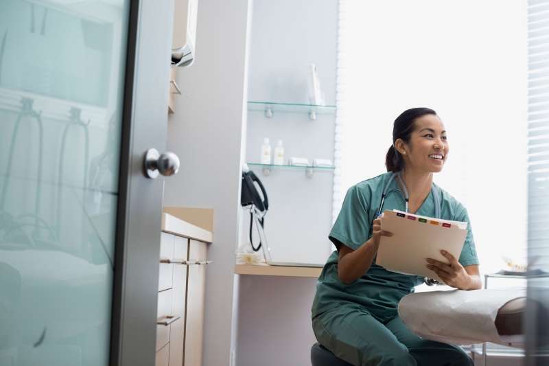 Smiling nurse looking over a patient's file