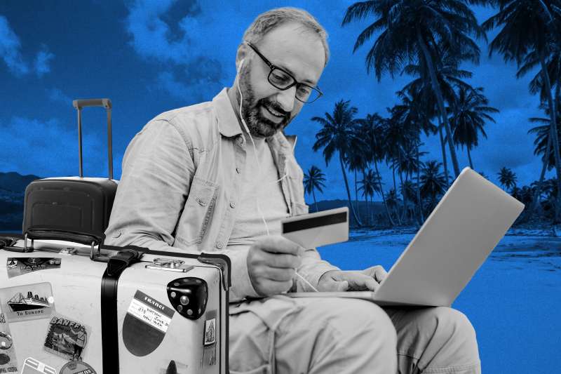 Man booking a trip with his credit card with a beach background