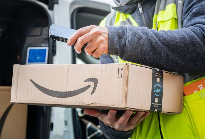 Amazon Prime delivery agent scanning barcodes on boxes during his work shift