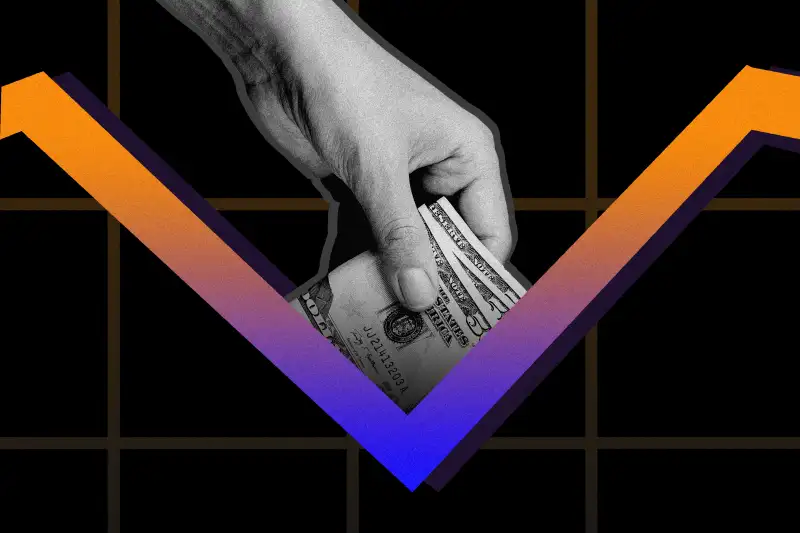 Hand with money putting it in the dip of a stock graph