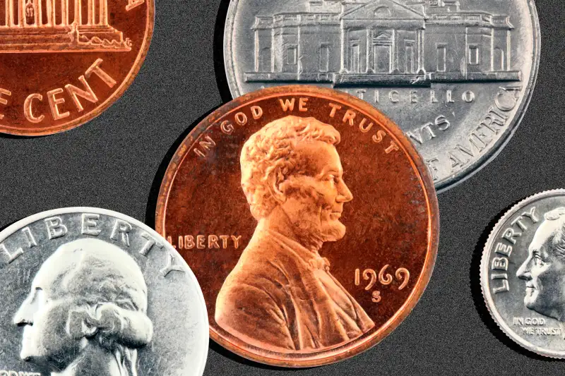 A penny, a quarter, a dime and a nickel, in a large size on a black background