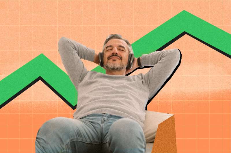 Man relaxing doing nothing while stock graph in the back goes up