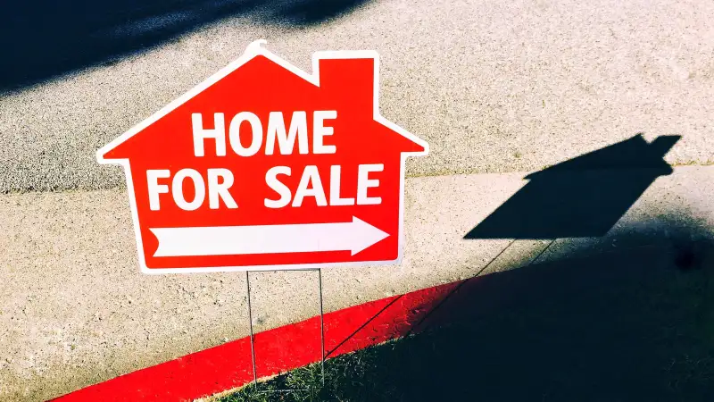 View of FOR SALE sign of a house