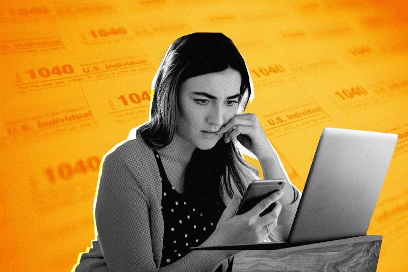Woman looking worried while looking at her phone with 1040 Tax form in the background