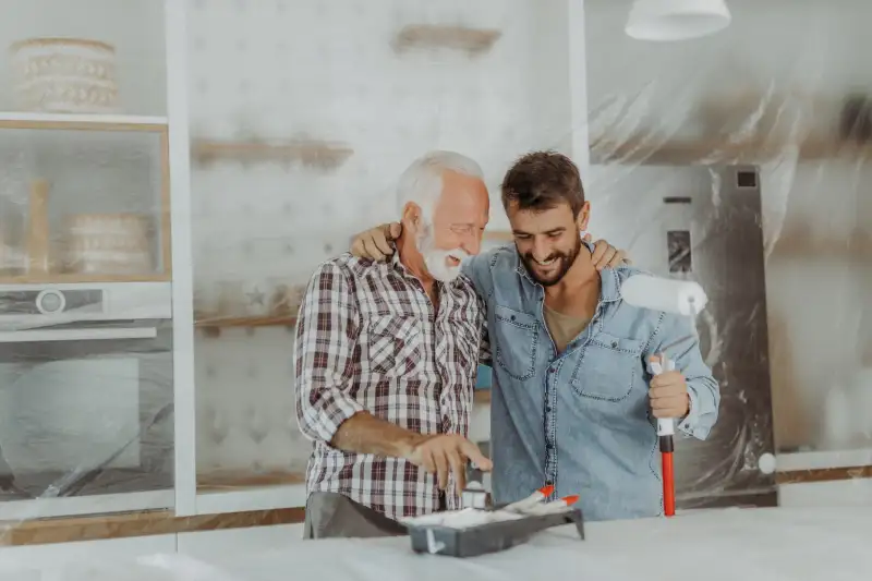 Father and son painting walls together