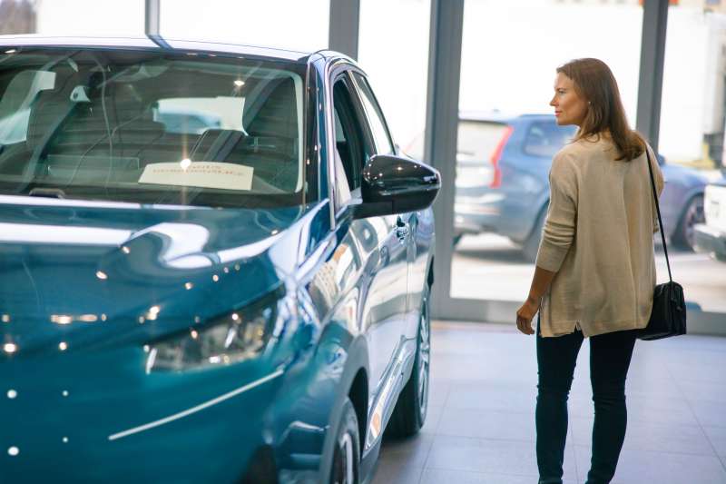 Woman looking at a car for lease
