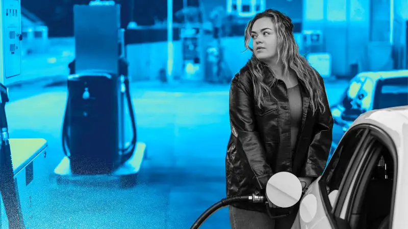 Photo of a woman pumping gas