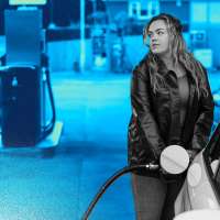 Photo of a woman pumping gas