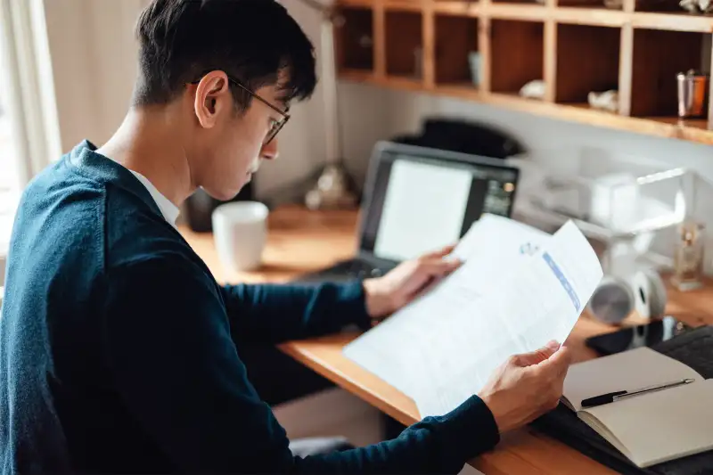 Man looking at his paper for financial reasons