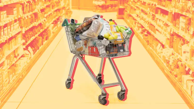 Full shopping cart in supermarket aisle