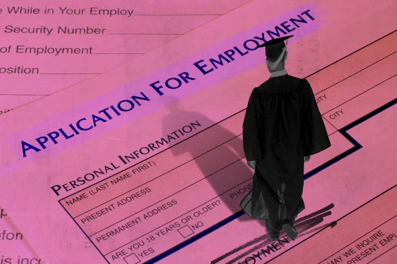 Student in graduation gown walking on oversized job application from