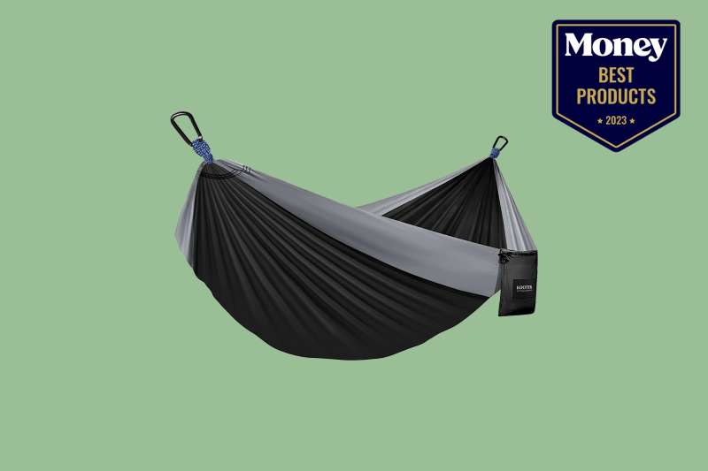 a black and grey hammock pictured on a solid sage green background