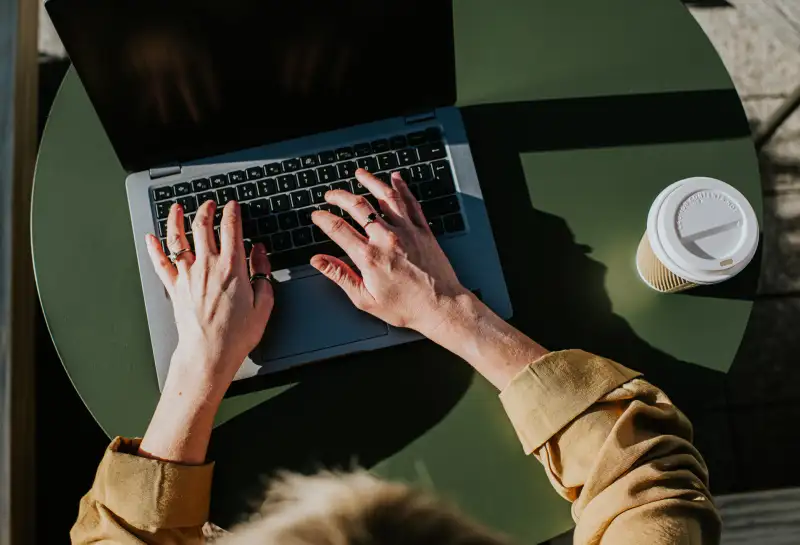 Close-up of hands typing on a laptop computer