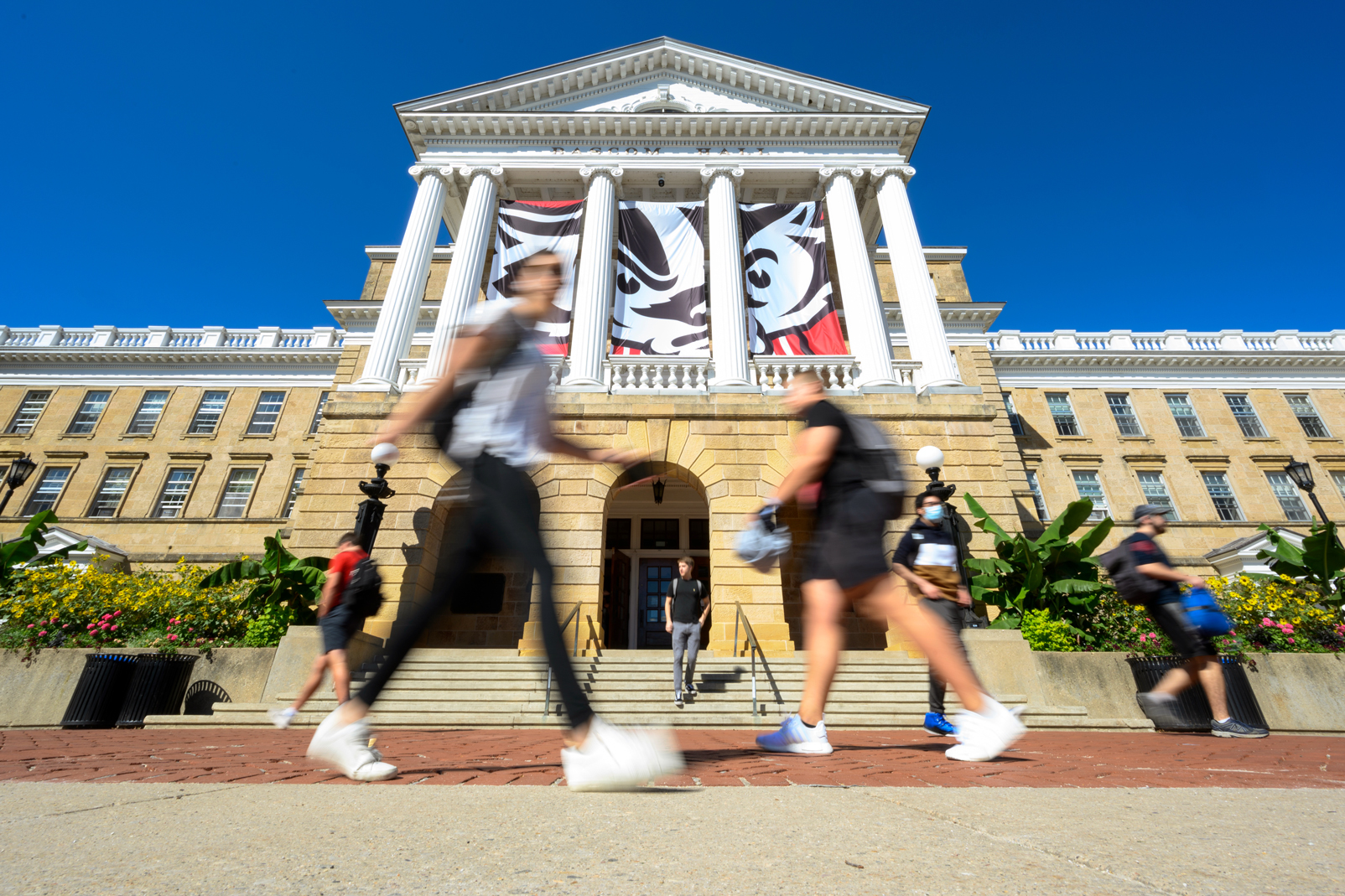 Students walking on campus on a sunny day at The University of Wisconsin-Madison